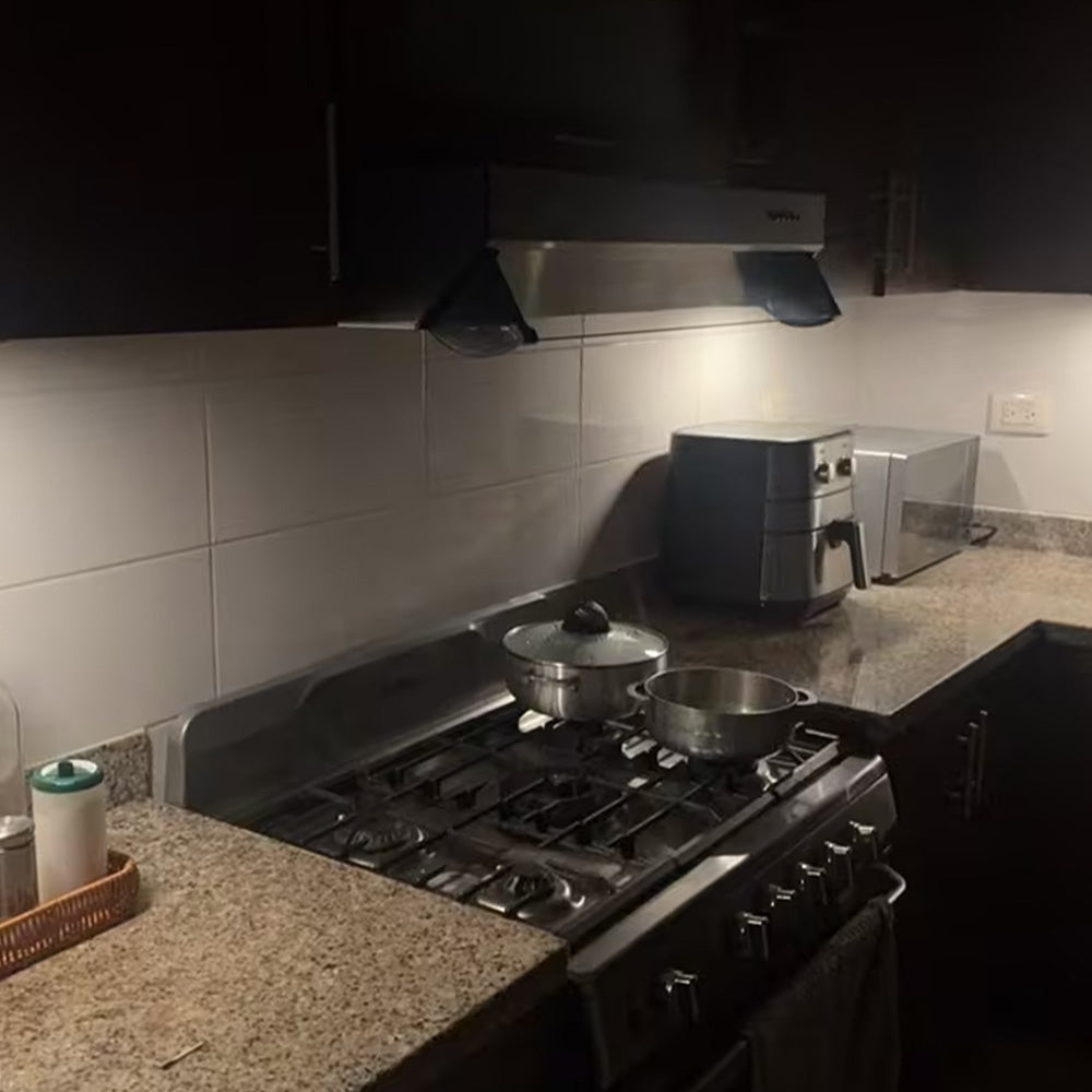 LED light bar lighting a kitchen worktop and stove at night