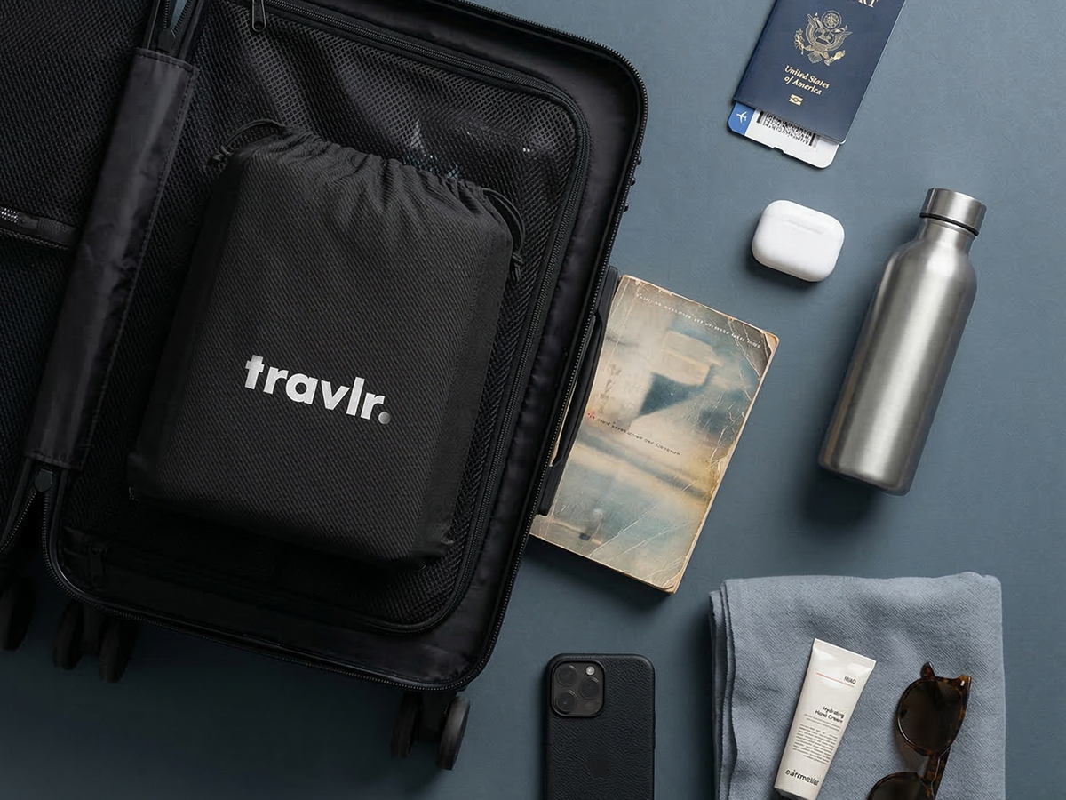 Folded cushion in its pouch inside a carry-on with travel essentials