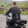 Rider sitting on his motorcycle in the riding position wearing the MotoSupport back support