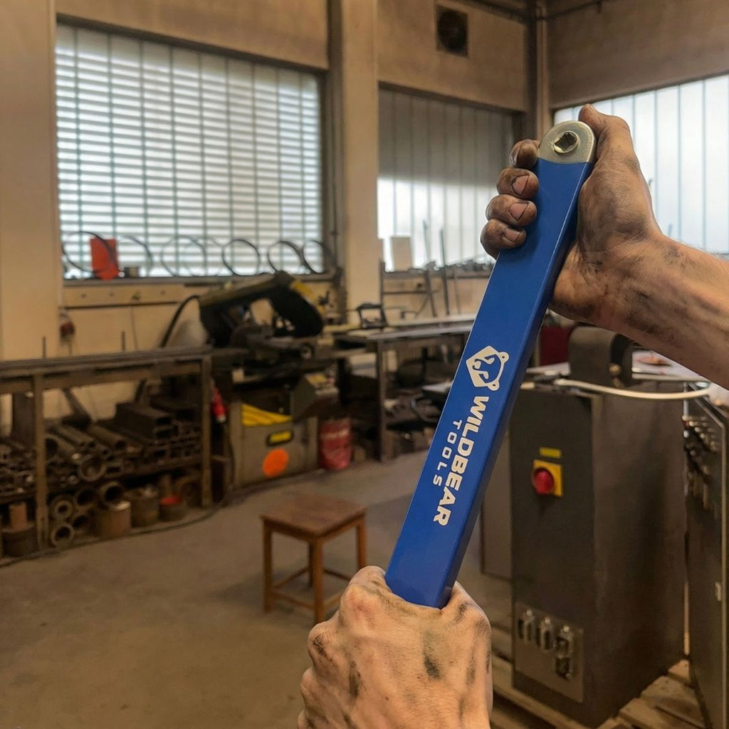 Hand holding the offset extension in a workshop