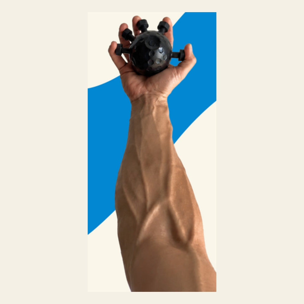 Muscular forearm squeezing the grip trainer ball