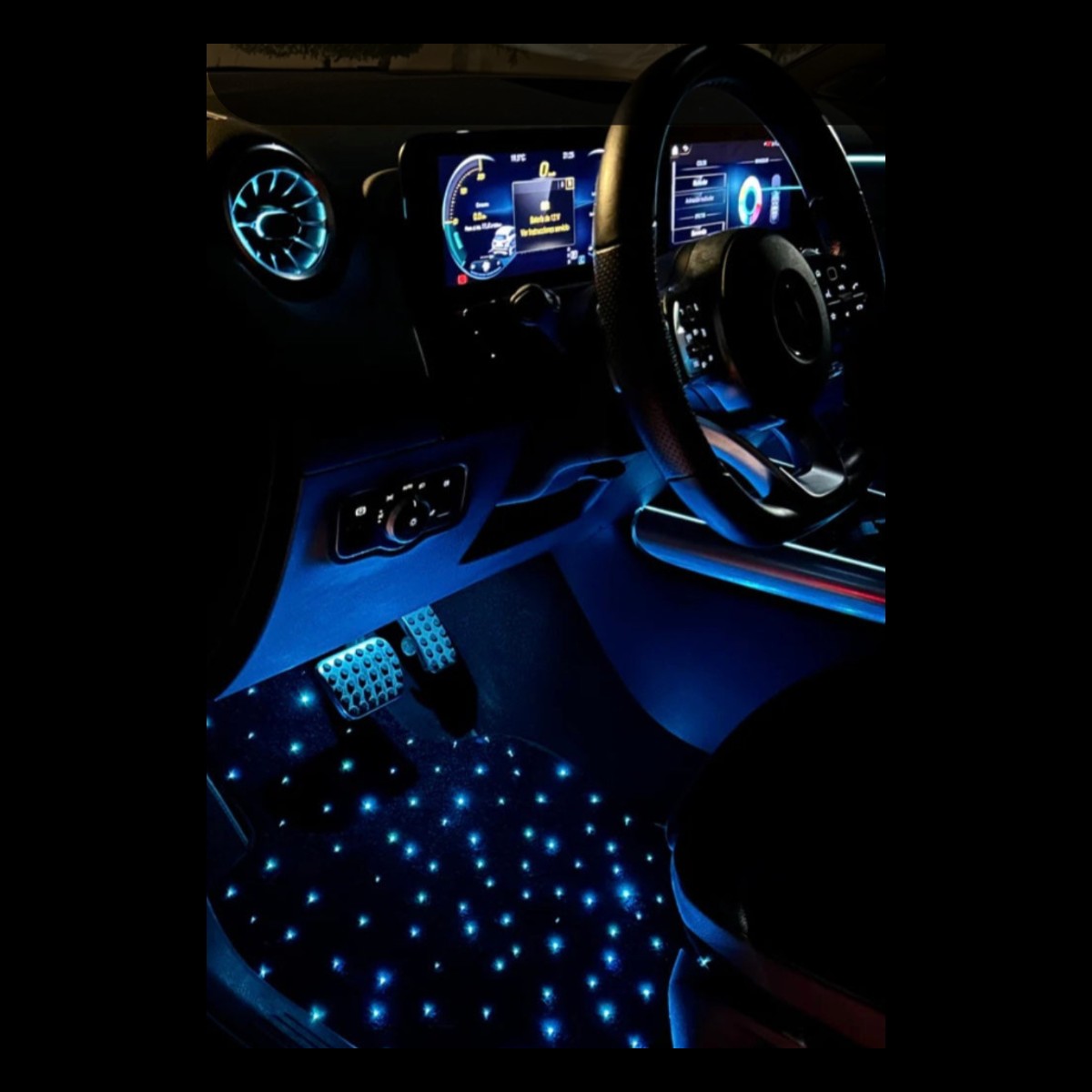 LED star car floor mat glowing in the footwell