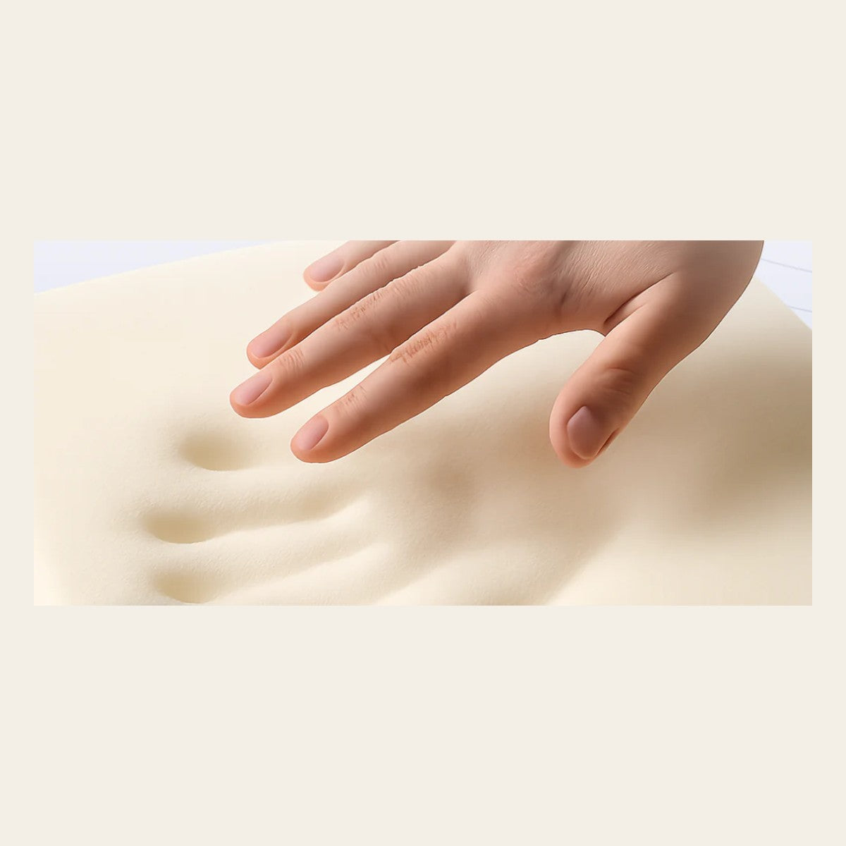 Hand pressing into the high-density memory foam of the pillow