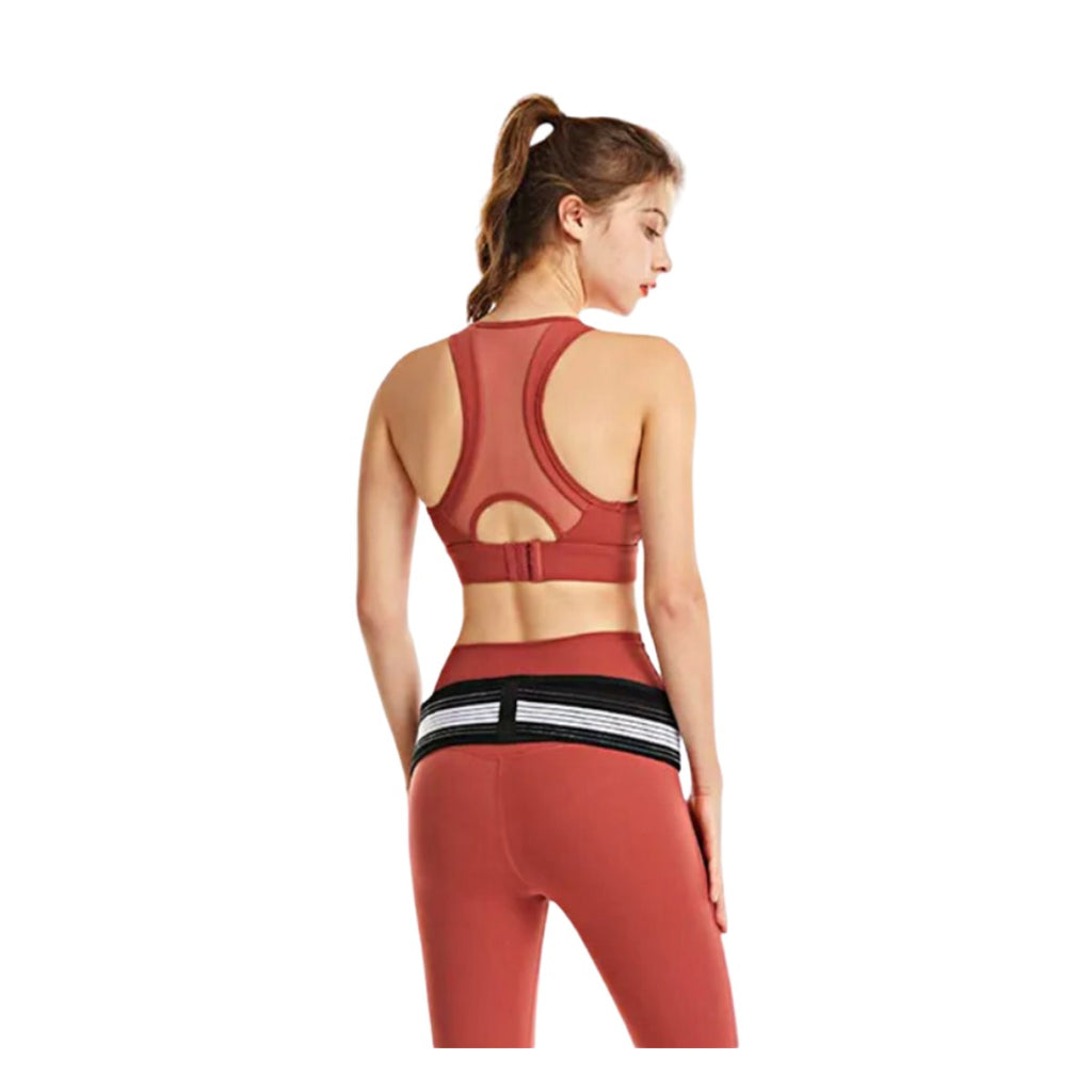 Woman wearing the sacroiliac hip belt around the hips