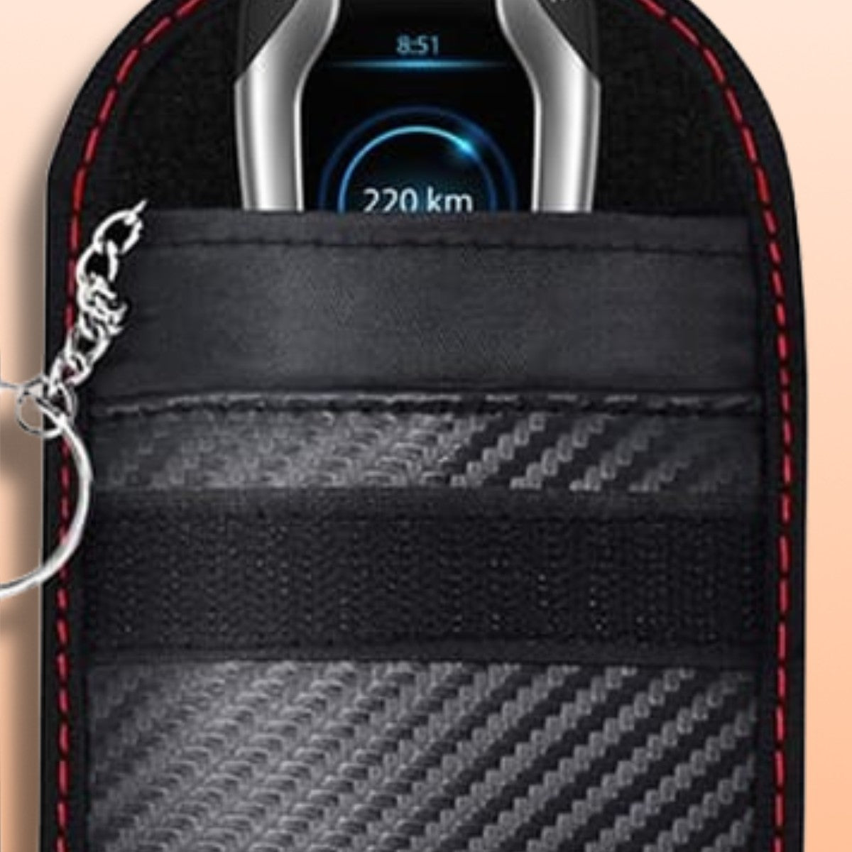 Close-up of a car key fob sliding into the signal blocking pouch