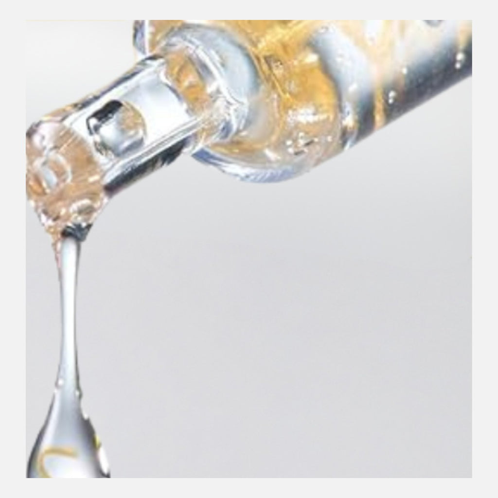 Dropper releasing a drop of collagen peptide serum