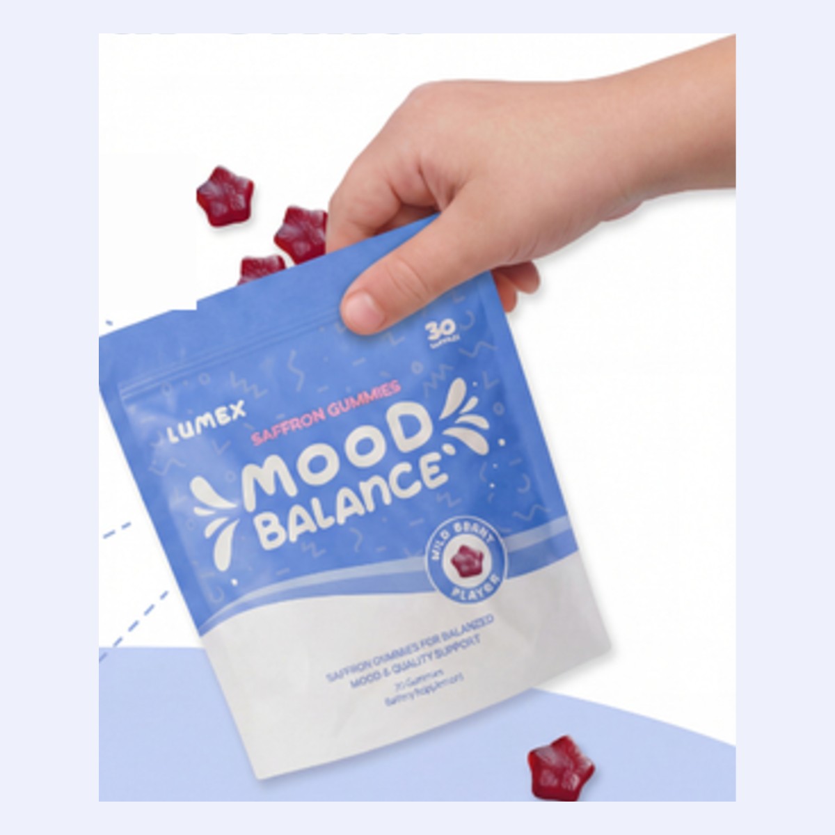 Hand holding saffron gummies pouch with gummies