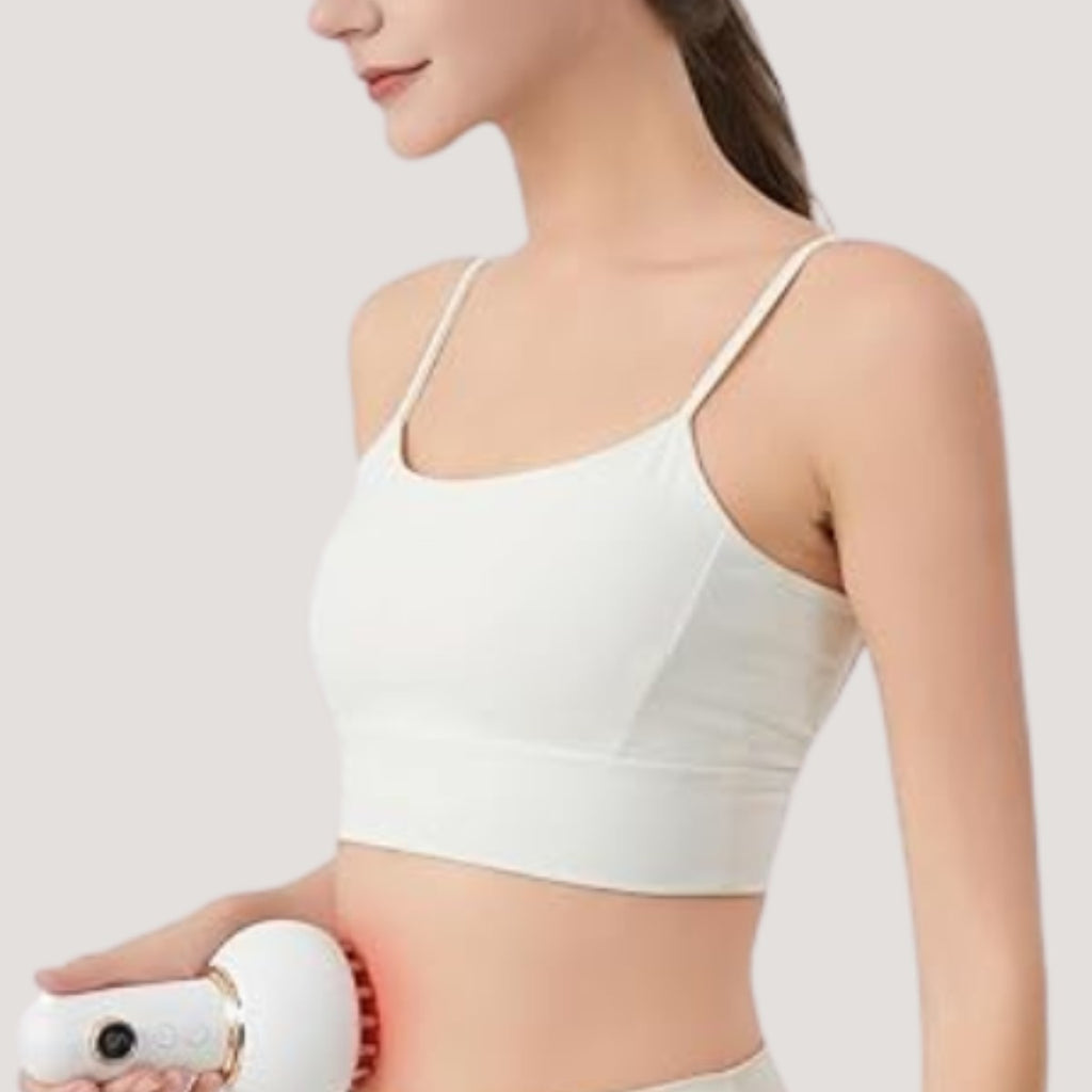 Woman using the electric body massager on her waist