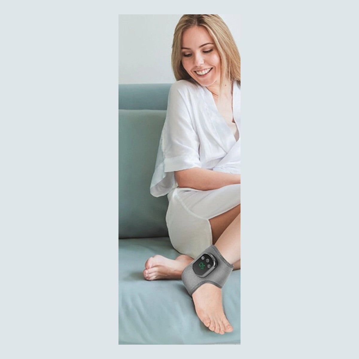 Woman relaxing on a sofa wearing the ankle massager
