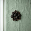 Dark botanical pieces on a green background