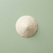 White postbiotic powder on a green background