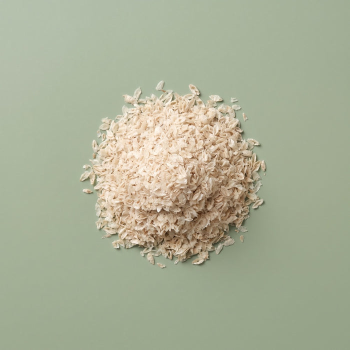 Flakes of prebiotic fibre on a green background