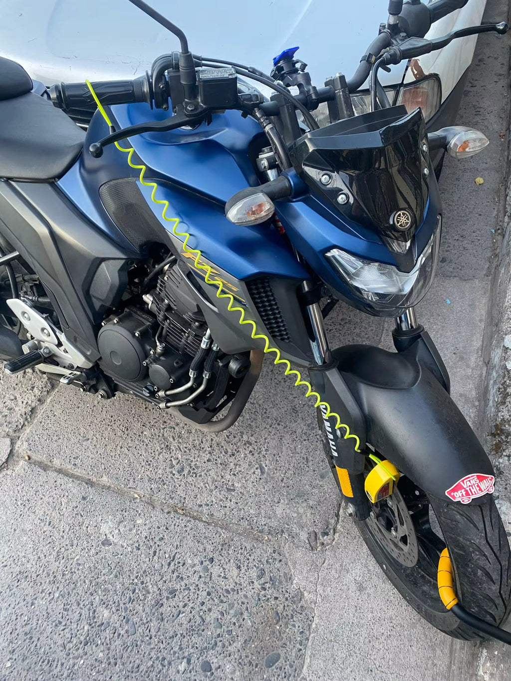 Motorbike with a disc lock and coiled hi-vis reminder cable