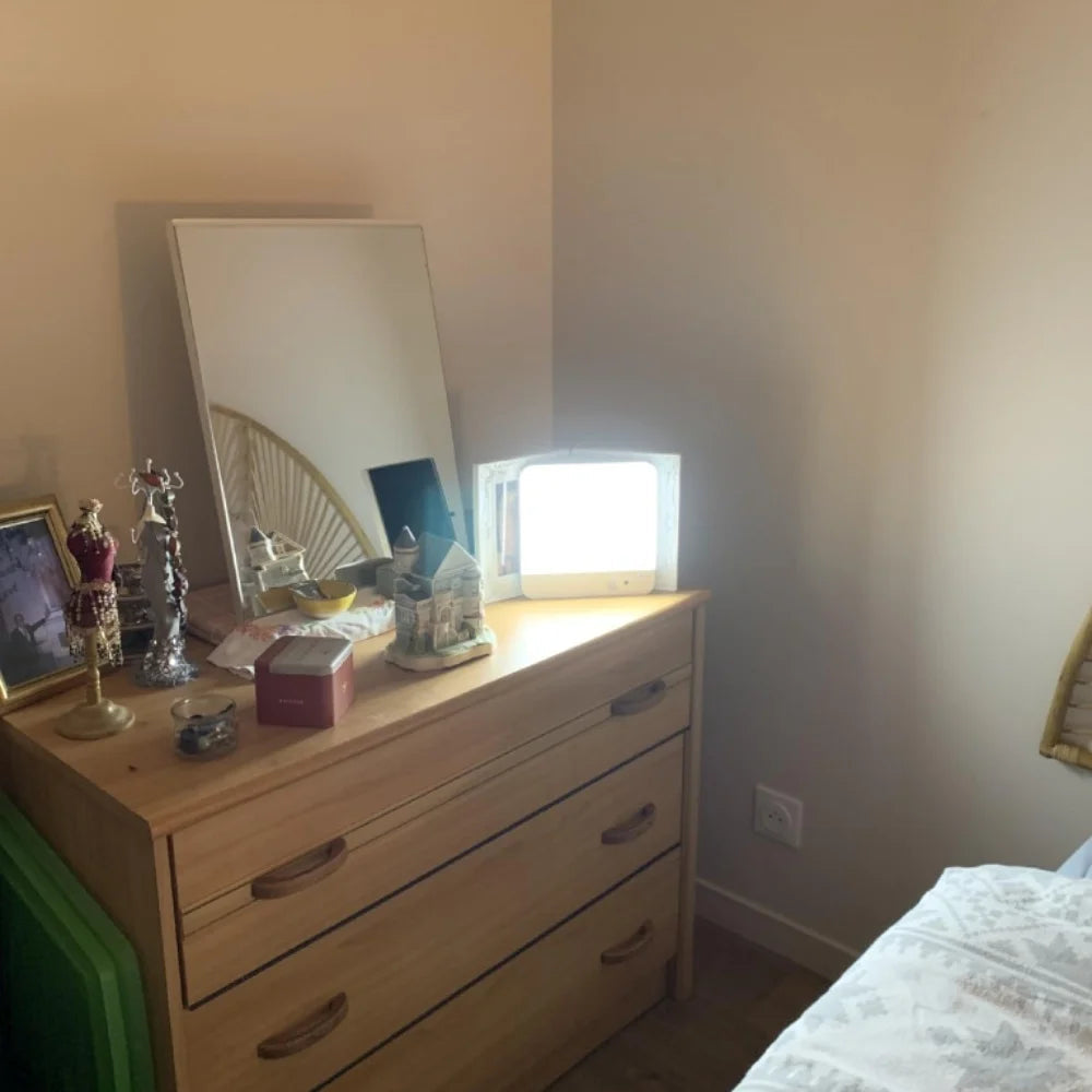 Light glowing above a bedroom dresser