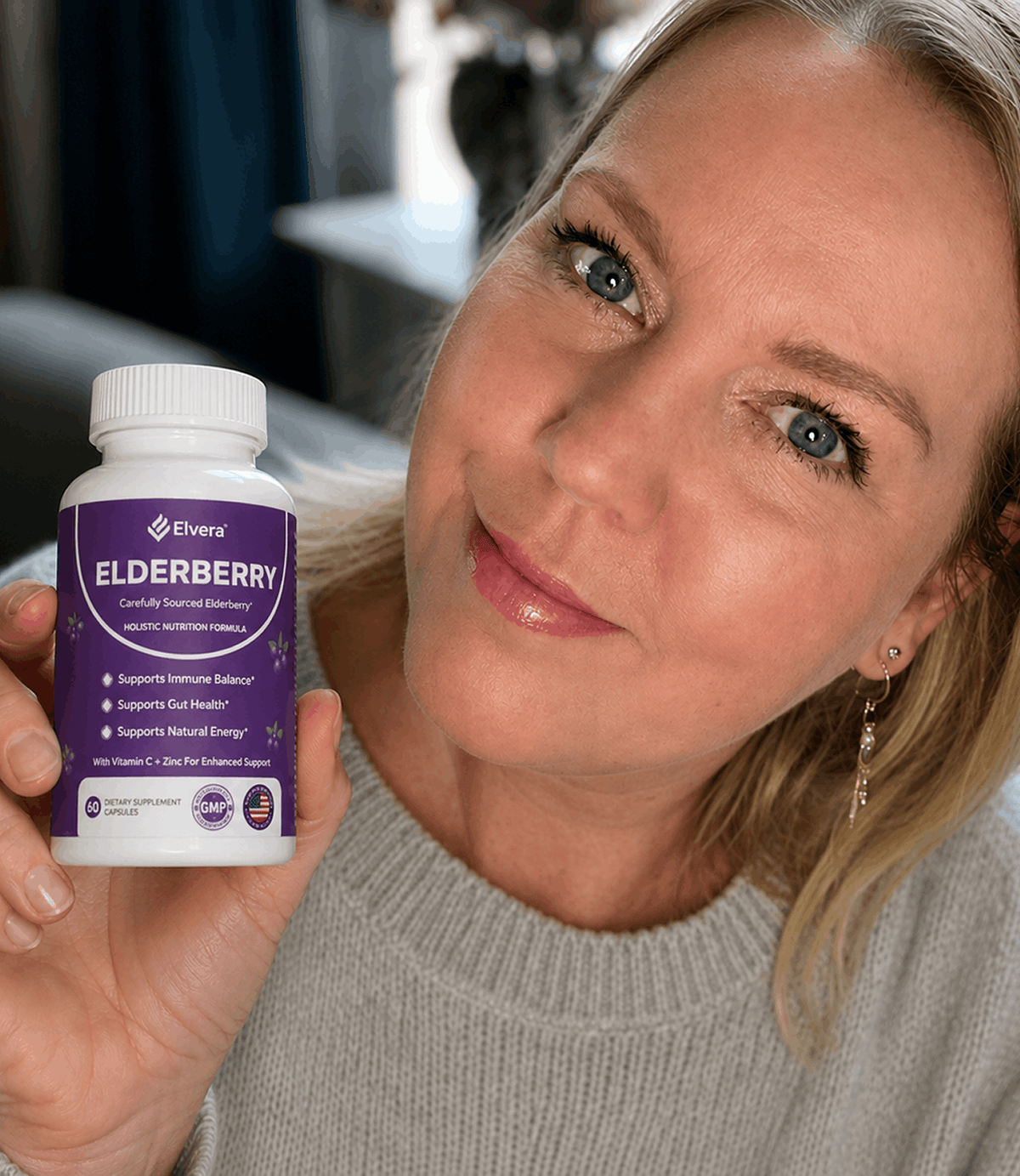 Woman smiling with the bottle of capsules