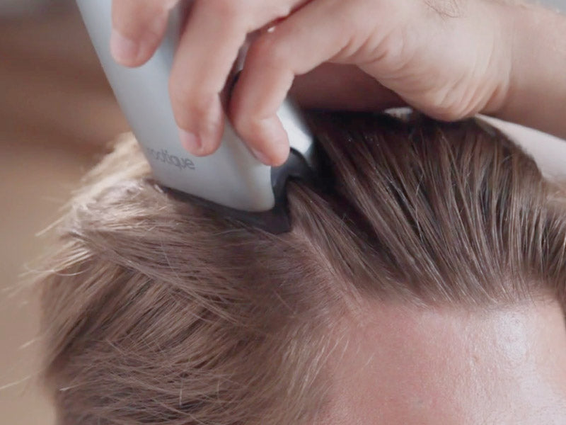 Applicator gliding through hair from the hairline
