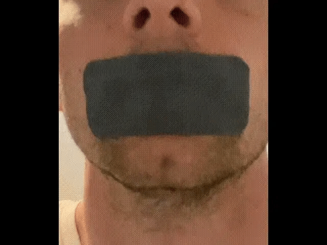 Close-up of a mouth tape strip on a man's lips